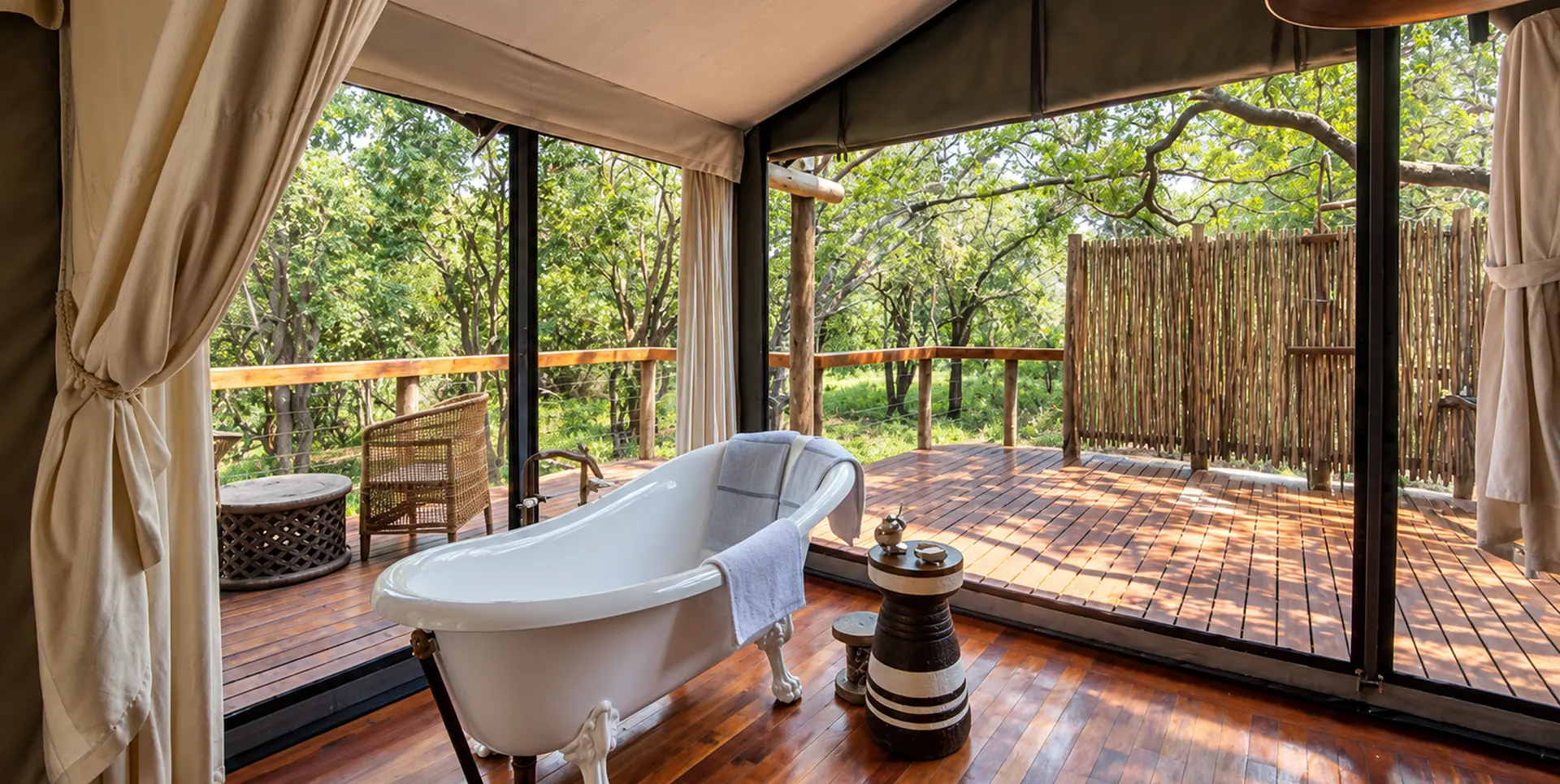 Freestanding bath on the deck of a tented safari suite