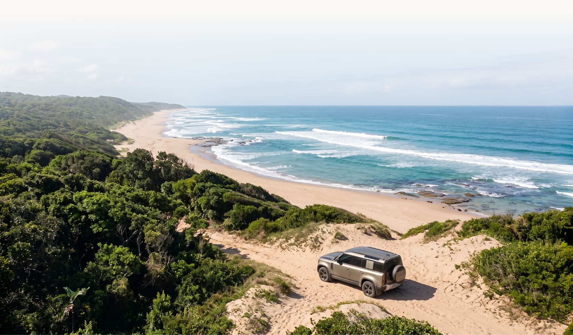 4x4 on a dune track above an empty beach
