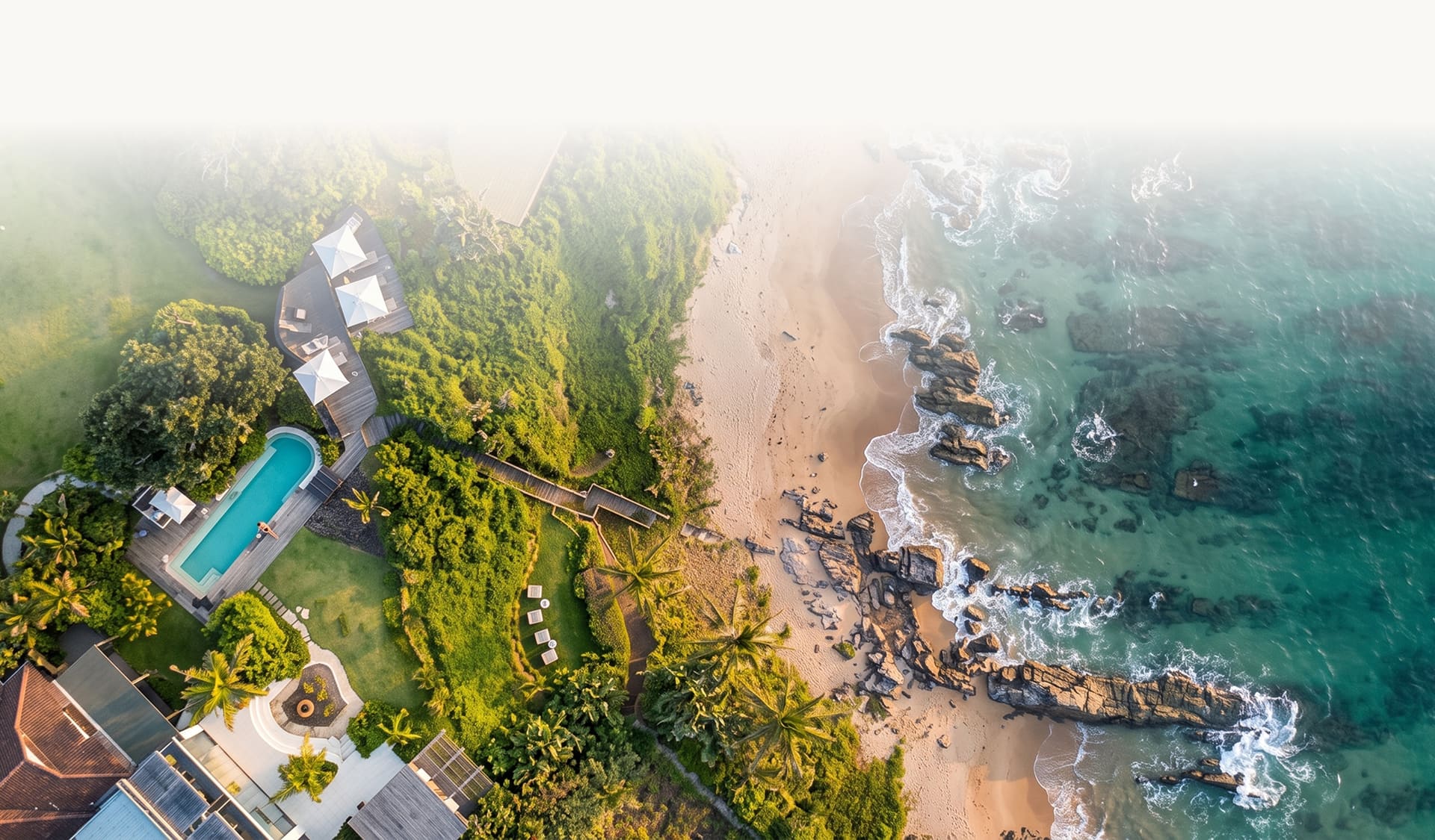Aerial view of Sala Beach House above Thompson’s Bay