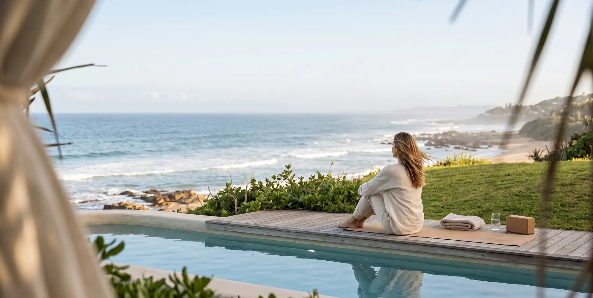 Woman resting by the pool facing the Indian Ocean